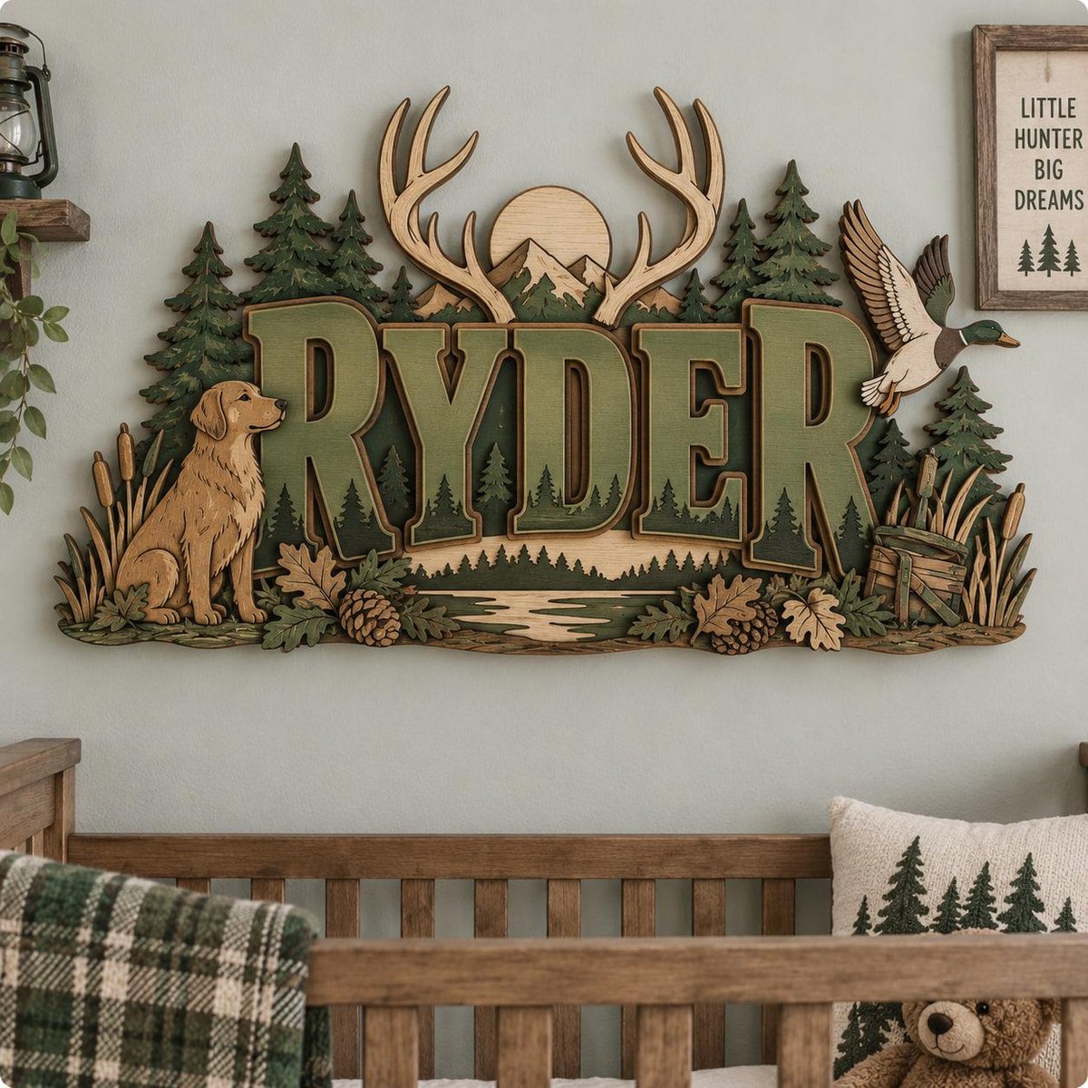 May include: A multi-layered wooden wall sign featuring the name RYDER in large green letters. The design includes a golden retriever, a flying duck, pine trees, mountains, a sun, and antlers. The scene depicts a forest landscape with oak leaves and pine cones.
