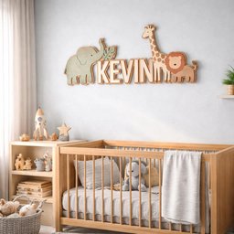 May include: Wooden nursery wall decor featuring the name "KEVIN" with an elephant, giraffe, and lion. The letters are light-colored, with the animals in muted green and brown. A wooden crib and bookshelf are in the foreground.