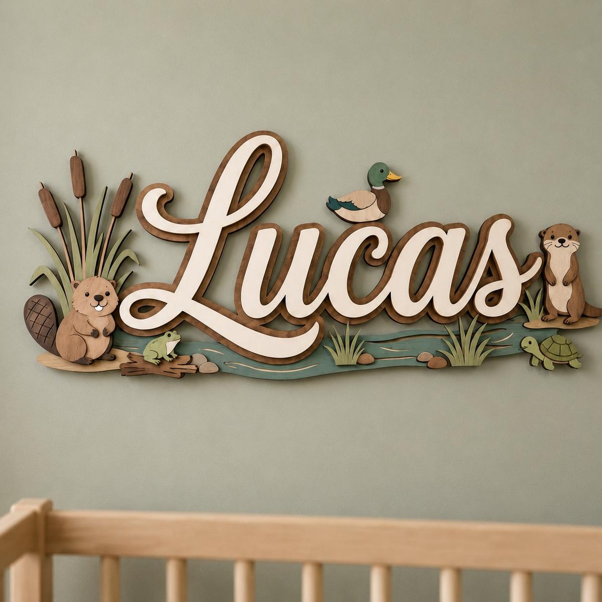 May include: A wooden wall sign featuring the name Lucas in white script lettering. The design includes layered cutouts of a beaver, a duck, a frog, a turtle, an otter, and cattails, all arranged along a painted blue river scene with brown accents.