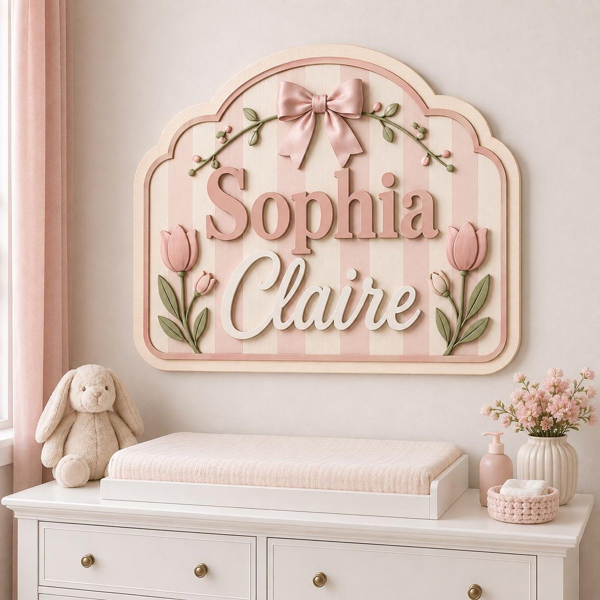 May include: A decorative wall sign featuring the name Sophia Claire in raised lettering. The sign has a light pink and white striped background, adorned with a pink bow at the top and two pink tulips with green stems on the sides.