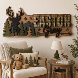 May include: A wooden wall sign featuring a black deer silhouette, green pine trees, and blue mountains. The name EASTON is in plaid block letters, and the name Gray is in black script. Decorative stars and arrows are included on the wood board.