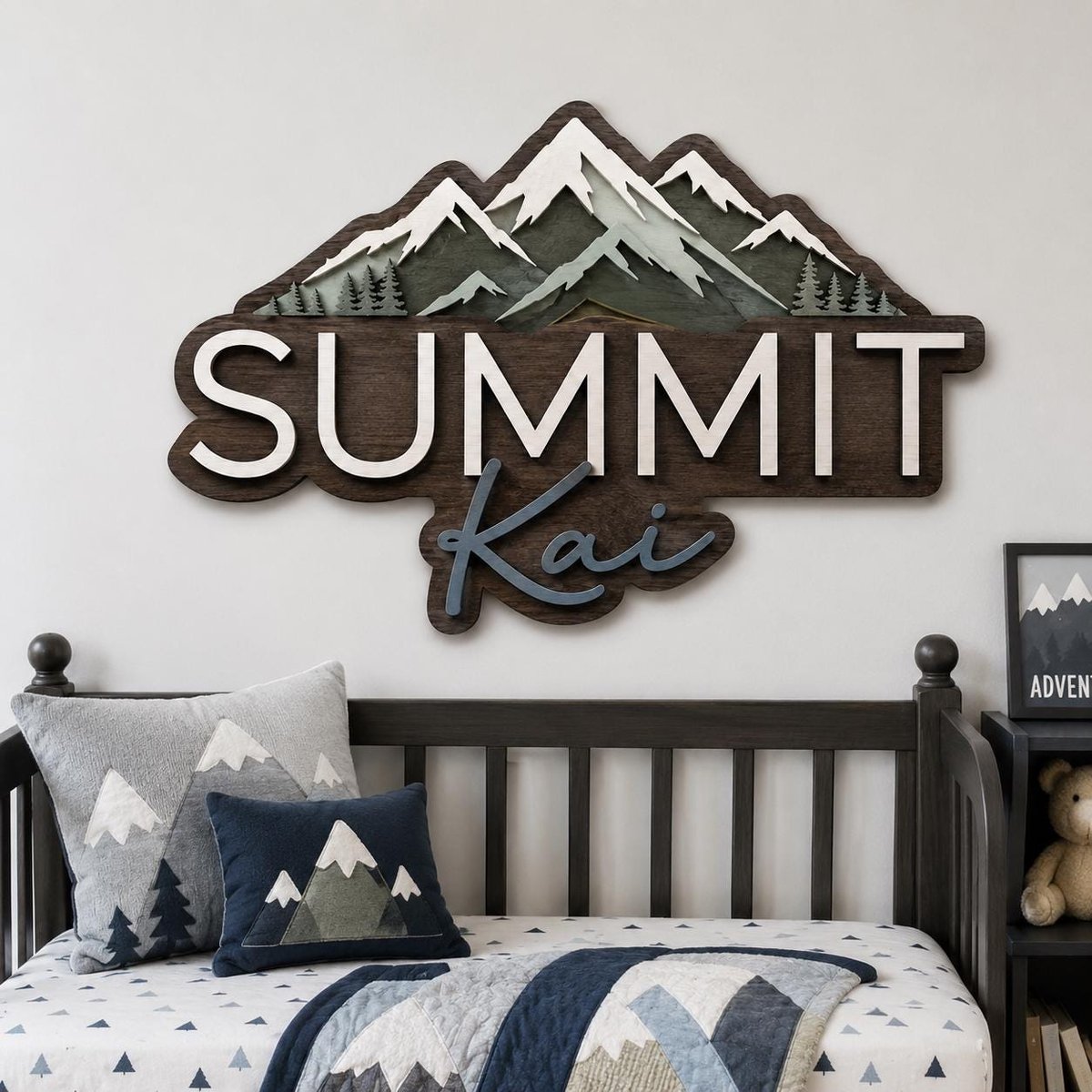 May include: A layered wooden wall sign featuring a mountain range silhouette with white snow-capped peaks and dark green pine trees. The sign displays the word SUMMIT in large white capital letters and the name Kai in blue script lettering.