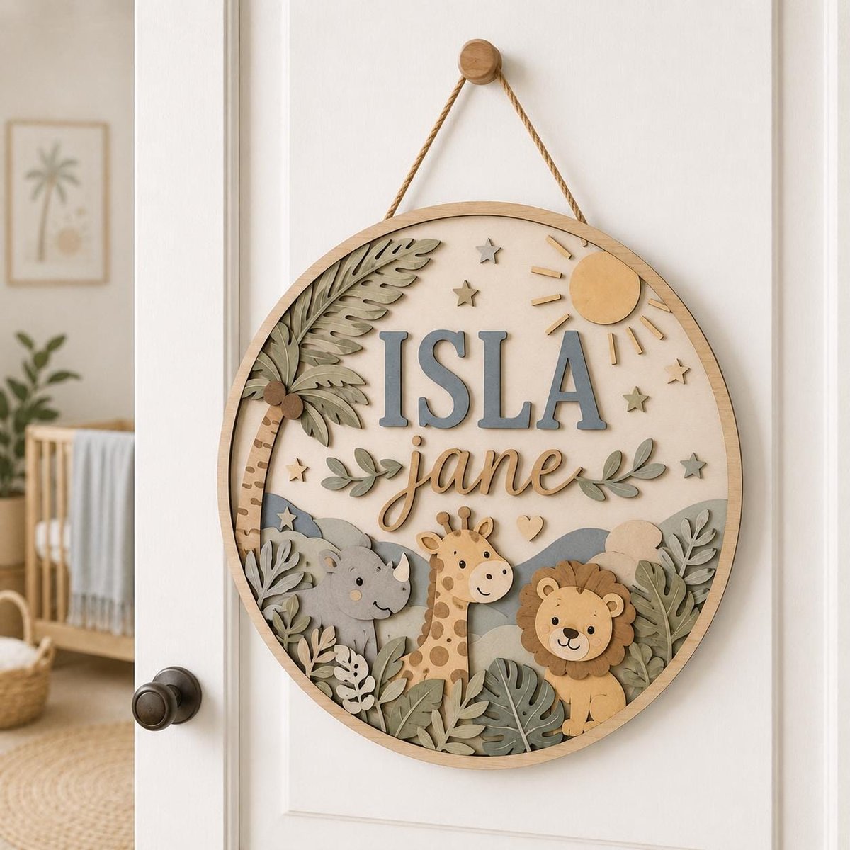 May include: A circular wooden wall sign featuring layered cutouts of a palm tree, sun, stars, and jungle animals including a rhino, giraffe, and lion. The name ISLA jane is displayed in the center with blue block and cursive brown lettering.