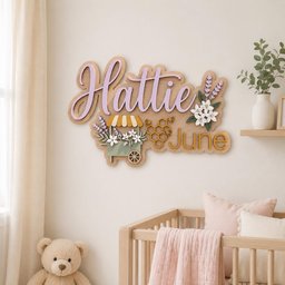 May include: A wooden wall sign featuring the name Hattie in large lavender script letters and the name June in gold block letters. The sign includes a decorative cart with a yellow striped awning, lavender flowers, and a golden honeycomb design.