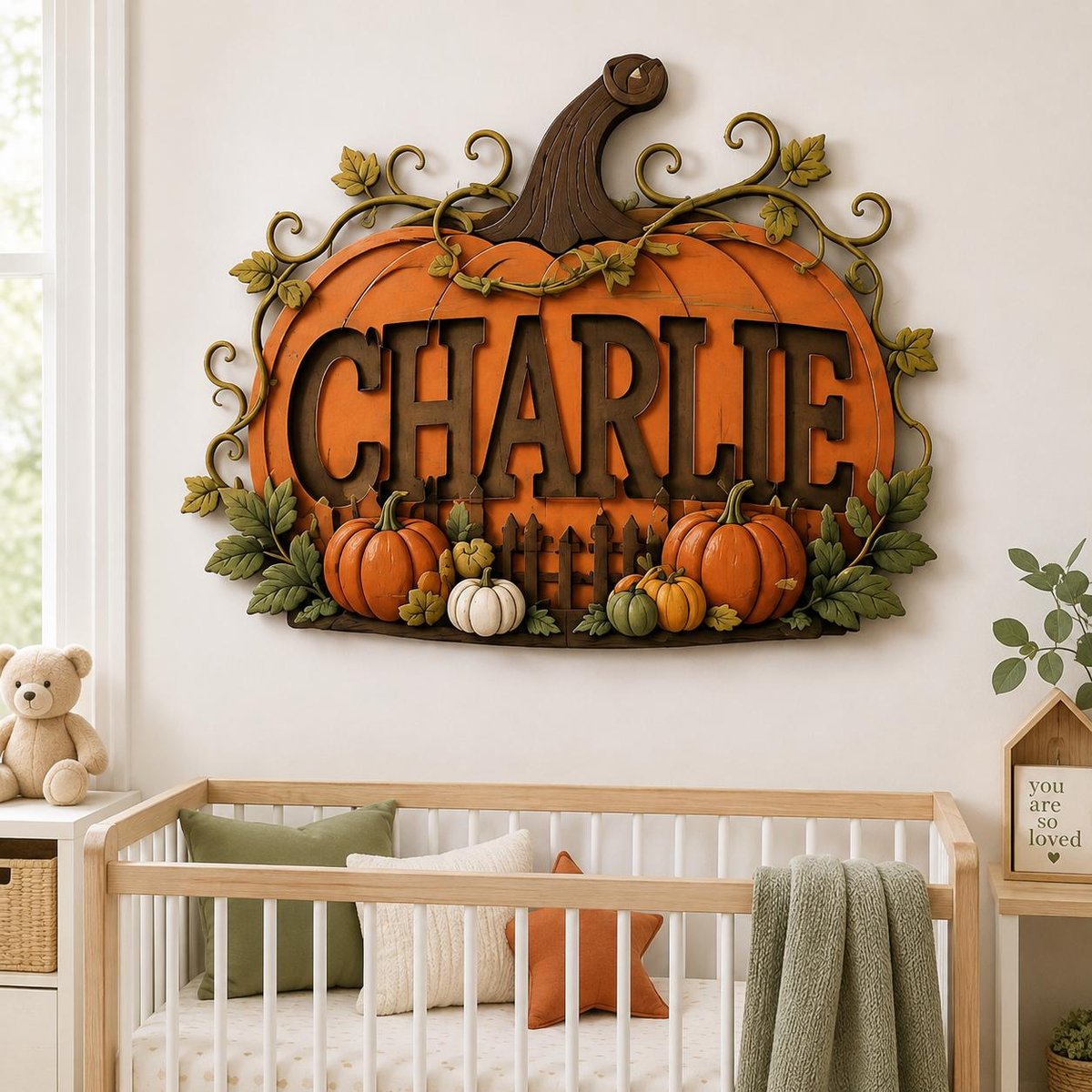 May include: A decorative wall sign shaped like a large orange pumpkin with the name CHARLIE in dark brown letters. The design features green vine accents, a brown stem, and smaller orange and white pumpkins at the base of the lettering.